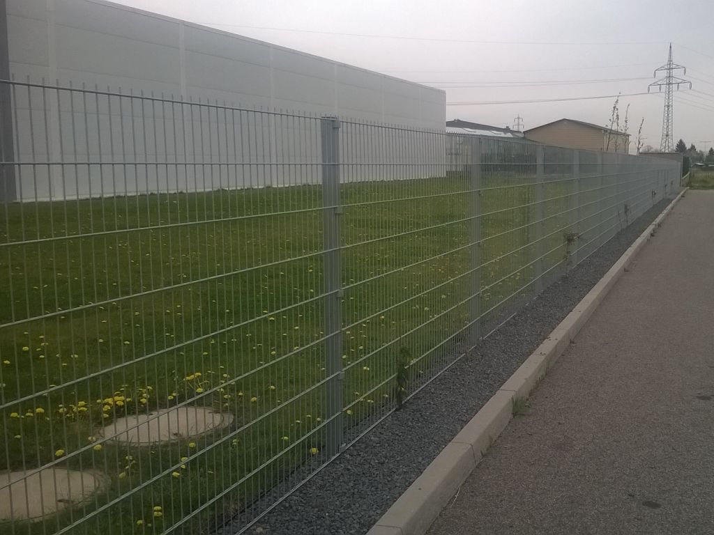 Modern fence around the premises made of galvanized nets